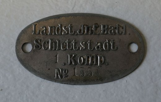 Erkennungsmarke eines Angehörigen der 1. Kompanie des Landsturm-Bataillons Schlettstadt (Inv.-Nr. 19516).